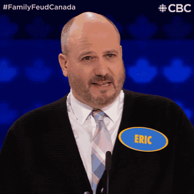a man in a suit and tie has a name tag that says eric