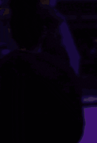 a blurred image of a woman in a black jacket