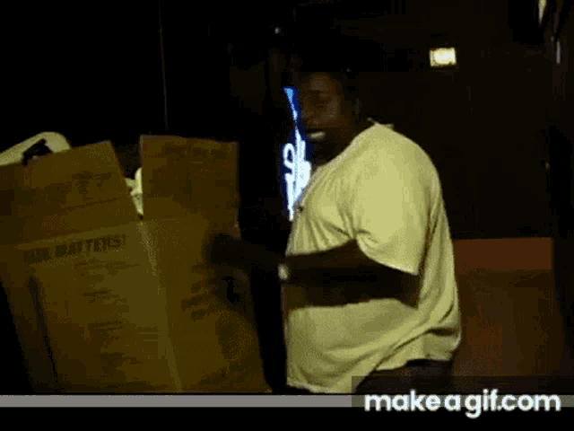a man in a white shirt is standing in front of a cardboard box that says " beer matters "