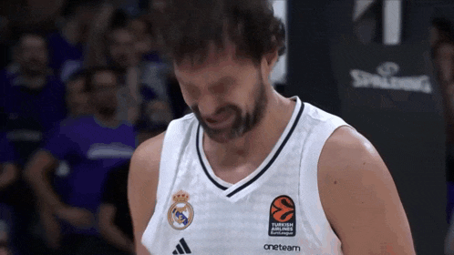 a basketball player wearing a white jersey that says one team