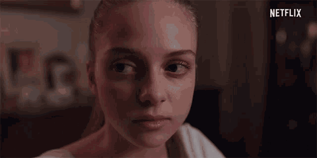 a close up of a woman 's face with a netflix logo in the corner