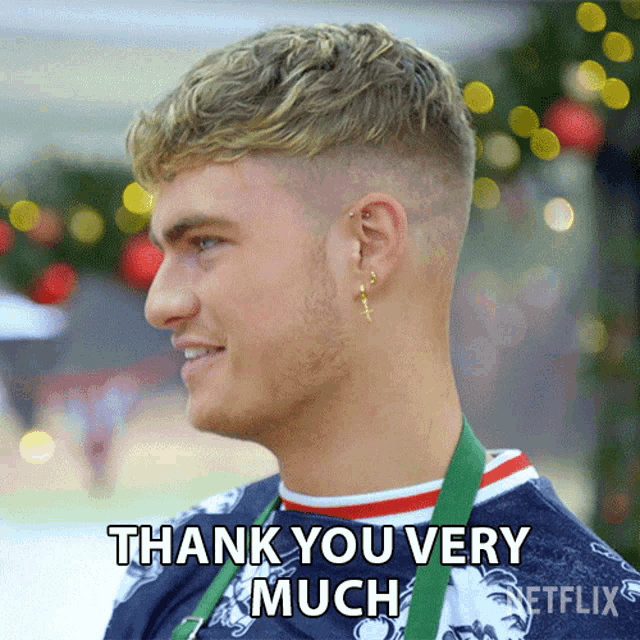 a man with a medal around his neck is giving a thank you very much sign