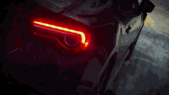 a close up of a car 's tail light that is red