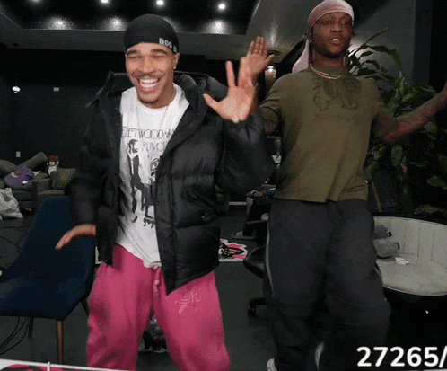two men are dancing and one has a shirt that says hollywood punch
