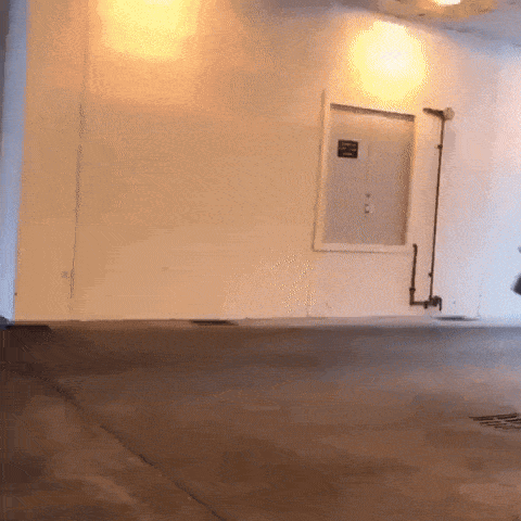 a white wall with a black sign on it that says ' emergency exit '