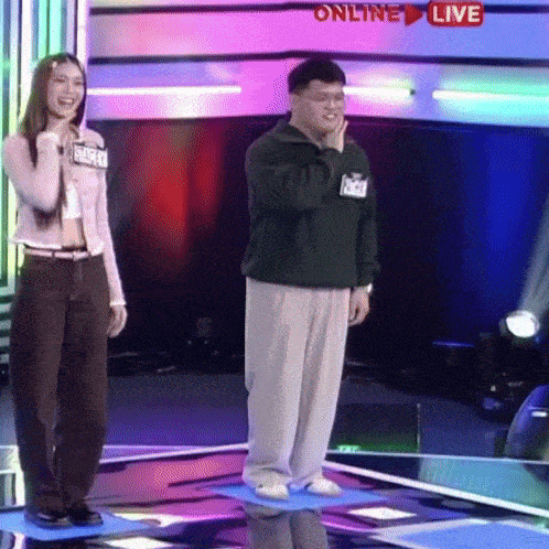 a man and a woman standing on a stage with the words online live on the bottom