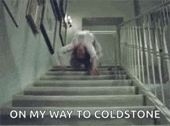 a woman is crawling down a set of stairs with the words `` on my way to coldstone '' written below her .