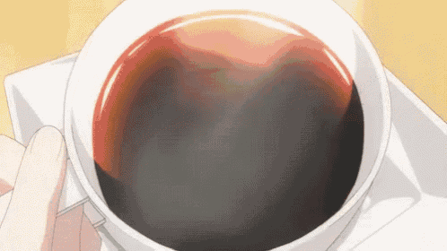 a close up of a person holding a cup of coffee .