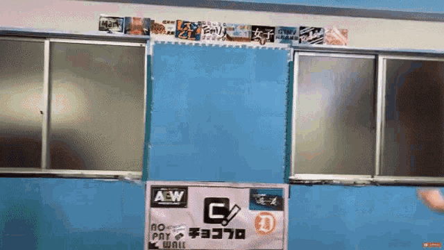 a blue wall with a pink sign that says aew on it