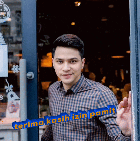 a man in a plaid shirt is standing in front of a glass door with the words terima kasih izin panic on it