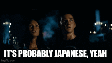 a man and a woman are standing next to each other with the words " it 's definitely japanese " on the screen