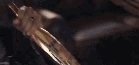 a person is holding a knife in their hand in a blurry picture .