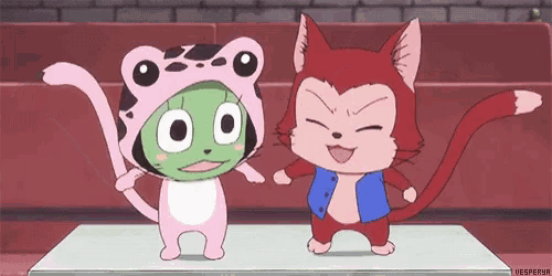 a frog and a cat are standing next to each other on a table