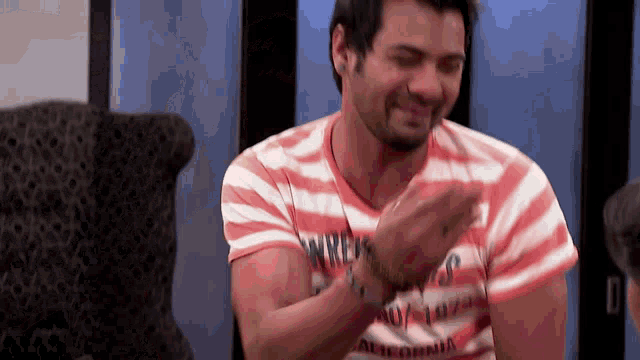 a man wearing a striped shirt that says ' california ' on it
