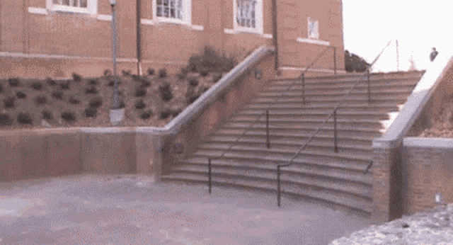 a set of stairs with a railing leading up to a building