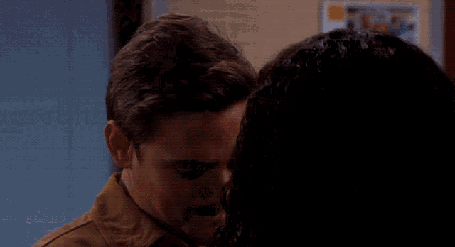 a man and woman are looking at each other