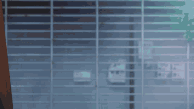 a girl with pink hair stands in front of a fence