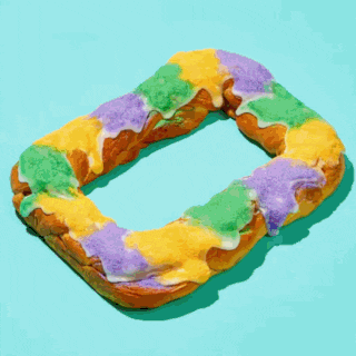 a king cake with green yellow and purple sprinkles on it