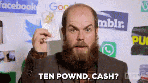 a man with a beard is holding a card in front of a wall with facebook twitter and google logos