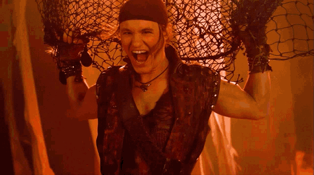 a man in a pirate outfit is holding a net over his head