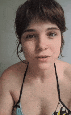 a woman with a nose ring and a bikini top