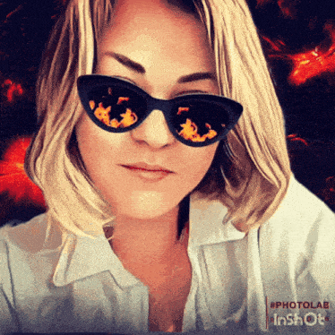 a woman wearing sunglasses has fire reflected in her glasses
