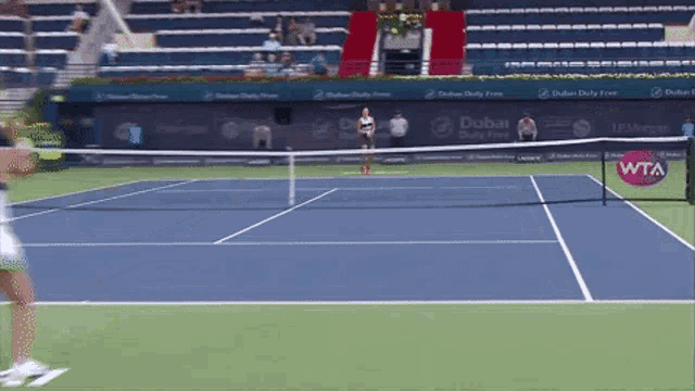 a tennis court with a dubai duty free banner