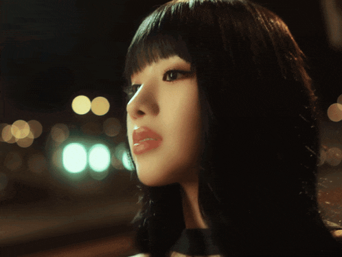 a close up of a woman 's face with a blurred background