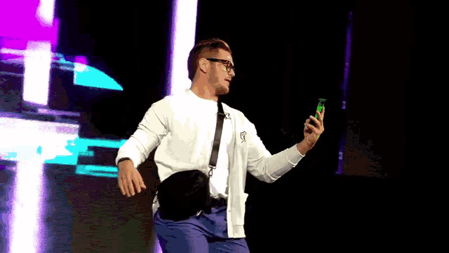 a man taking a picture of himself with a green cell phone