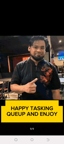 a man with a beard is giving a thumbs up in a restaurant