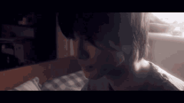 a close up of a person 's face in a dark room