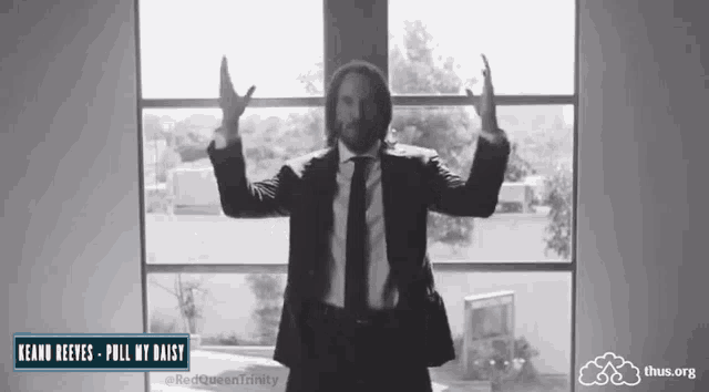 a man in a suit and tie is standing in front of a window with the words pull my daisy on the bottom right