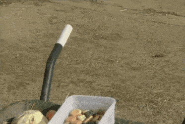 a doll with a big nose is sitting in a wagon