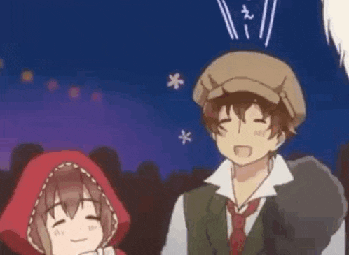 a man and a little red riding hood are standing next to each other in a crowd .