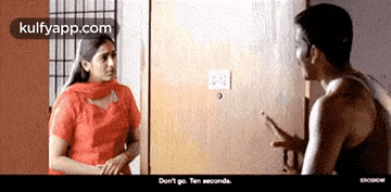 a man and a woman are standing next to each other and talking .