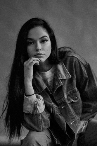 a black and white photo of a woman with long hair