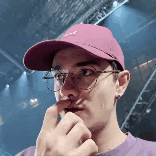 a man wearing glasses and a pink hat with the word levis on it