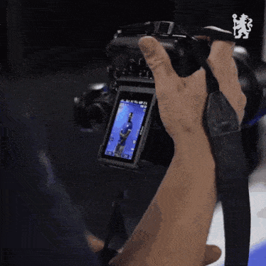 a person is taking a picture with a camera that says ' nikon ' on the strap