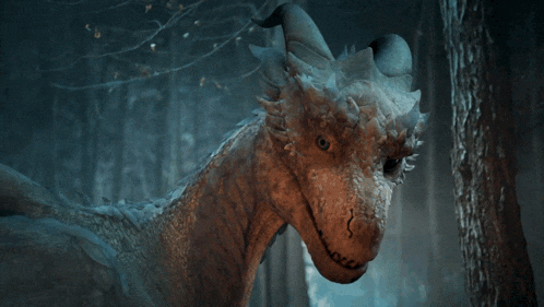 a close up of a dragon 's head in a forest