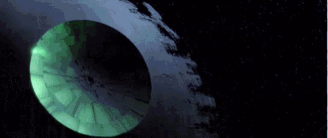 a green laser beam is coming out of a hole in the earth