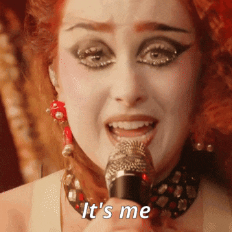 a woman singing into a microphone with the words " it 's me " above her