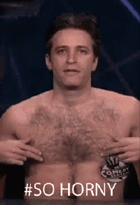 a man without a shirt is holding his chest with his hands and says # so horny .