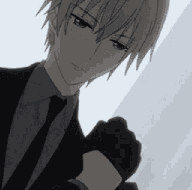 a man in a suit and tie is wearing gloves