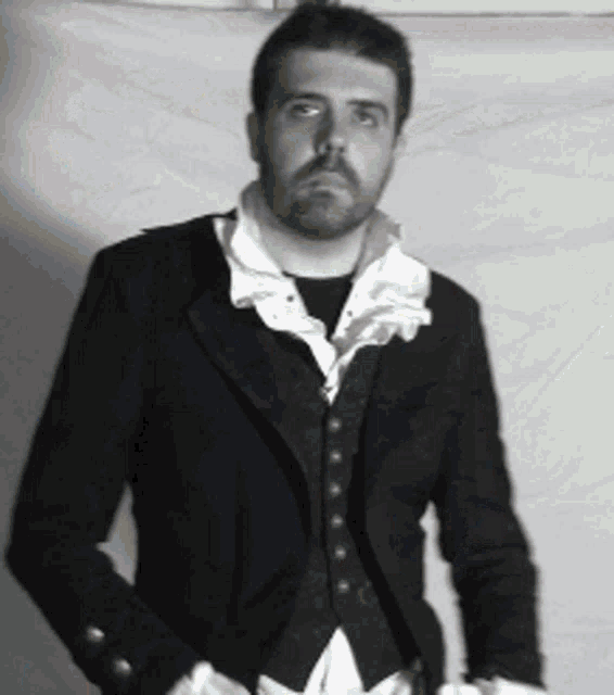 a man with a beard is wearing a black jacket