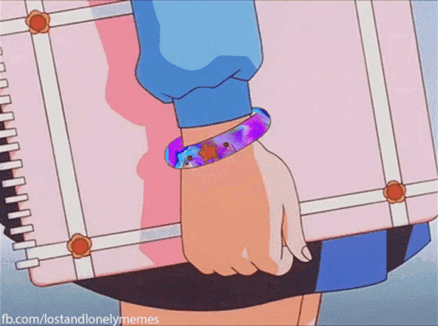 a girl with a bracelet on her wrist is holding a pink notebook