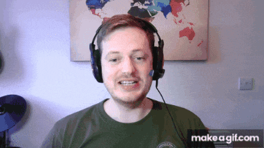 a man wearing headphones is smiling in front of a world map
