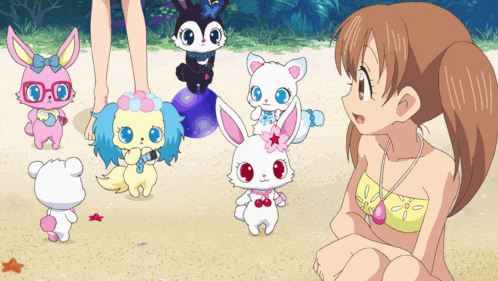a girl in a bikini sits on the beach with a bunch of stuffed animals around her