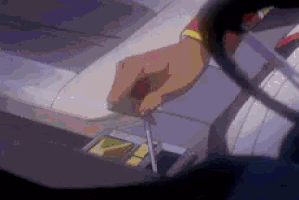 a close up of a person holding a screwdriver in a car