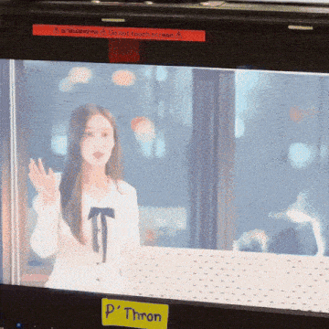 a woman is on a screen with a yellow sticker that says " p ' throne "
