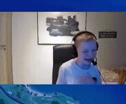 a boy wearing headphones is sitting in front of a computer